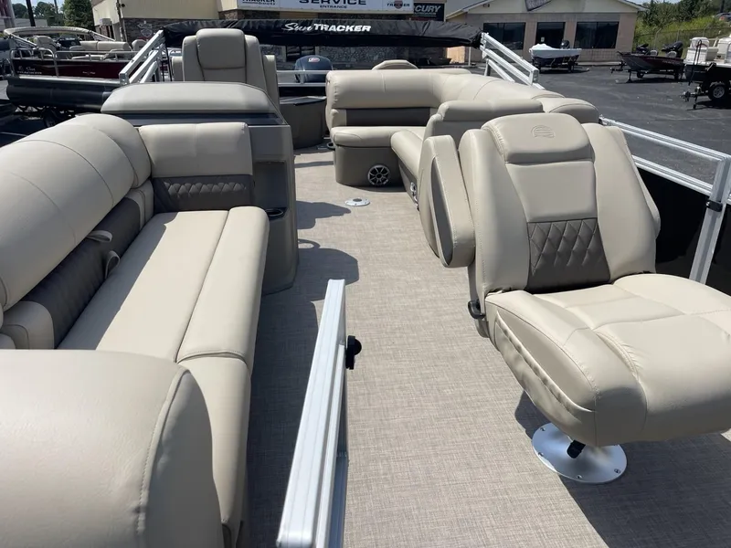 Slide: The Image of 2025 Sun Tracker SportFish 20 DLX pontoon boat with beige seating and spacious deck. - 4