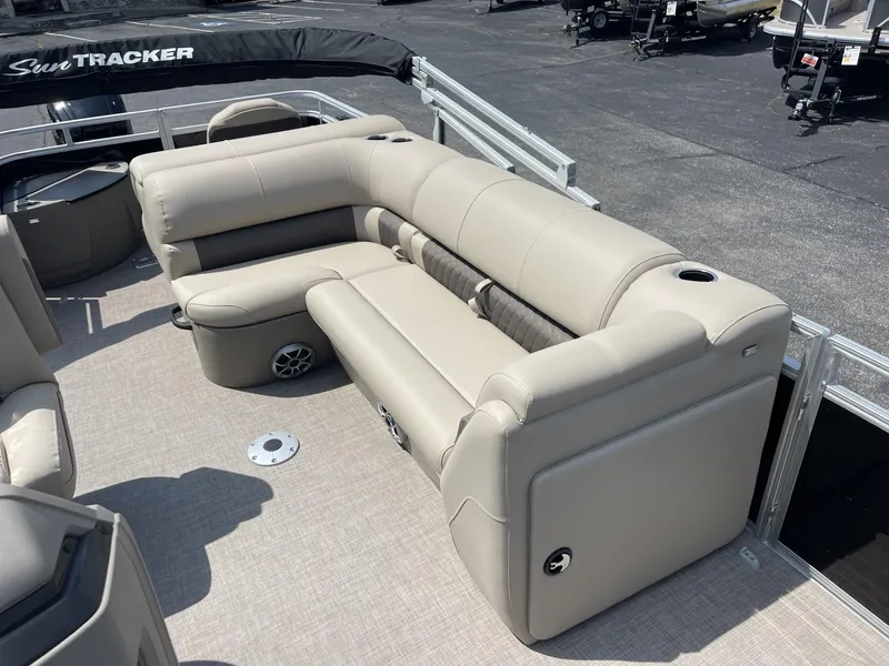 Slide: The Image of 2025 Sun Tracker SportFish 20 DLX pontoon boat with beige seating and spacious deck. - 7