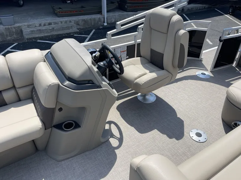 Slide: The Image of 2025 Sun Tracker SportFish 20 DLX boat interior with beige seating and steering console. - 8
