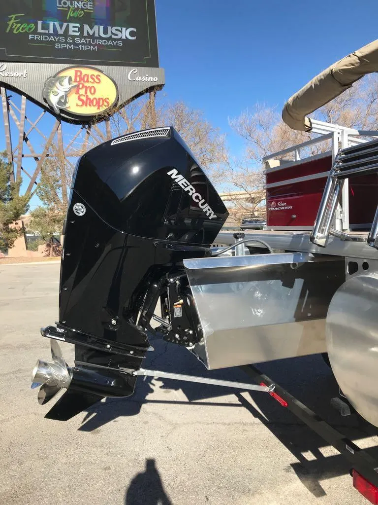Slide: The Image of 2025 Sun Tracker Party Barge 22 RF XP3 with Mercury outboard motor in parking lot. - 4