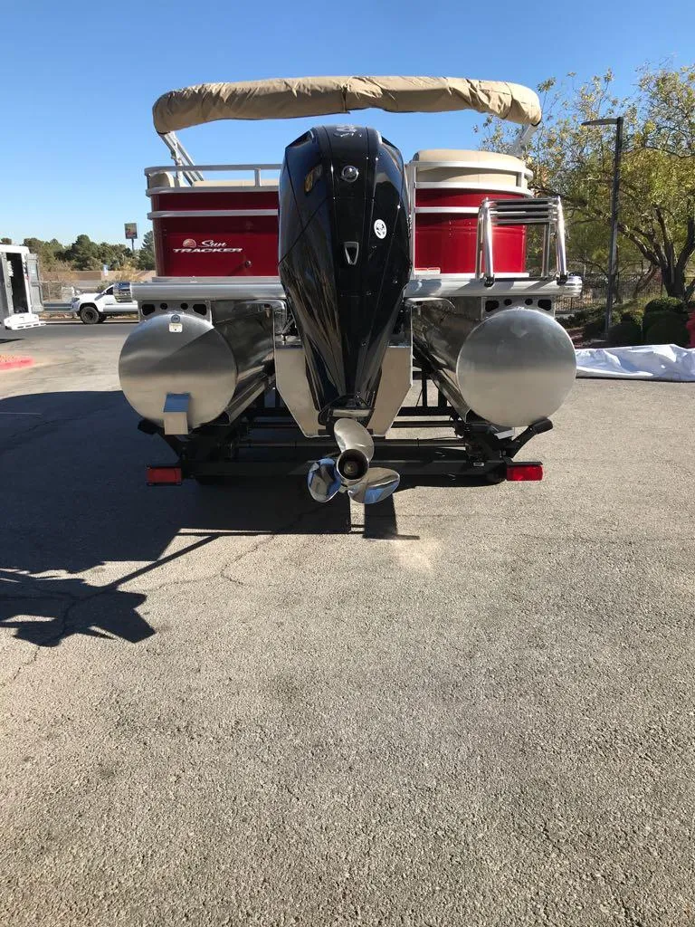 Slide: The Image of 2025 Sun Tracker Party Barge 22 RF XP3 pontoon boat, rear view, parked outdoors. - 6