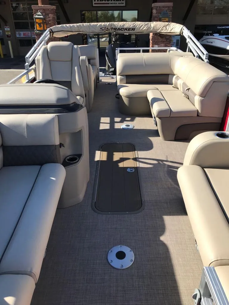 Slide: The Image of 2025 Sun Tracker Party Barge 22 RF XP3 interior with beige seating and spacious layout. - 8