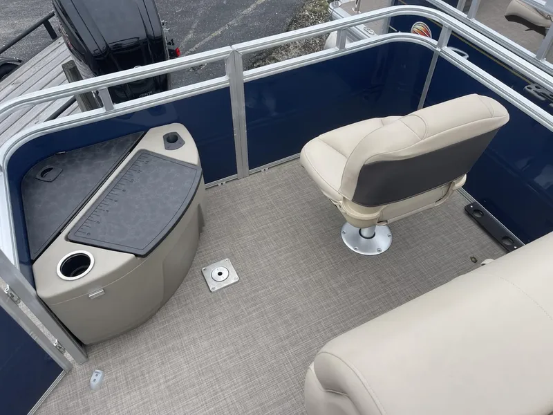 Slide: The Image of 2025 Sun Tracker Fishin' Barge 20 DLX interior with seating and storage. - 10