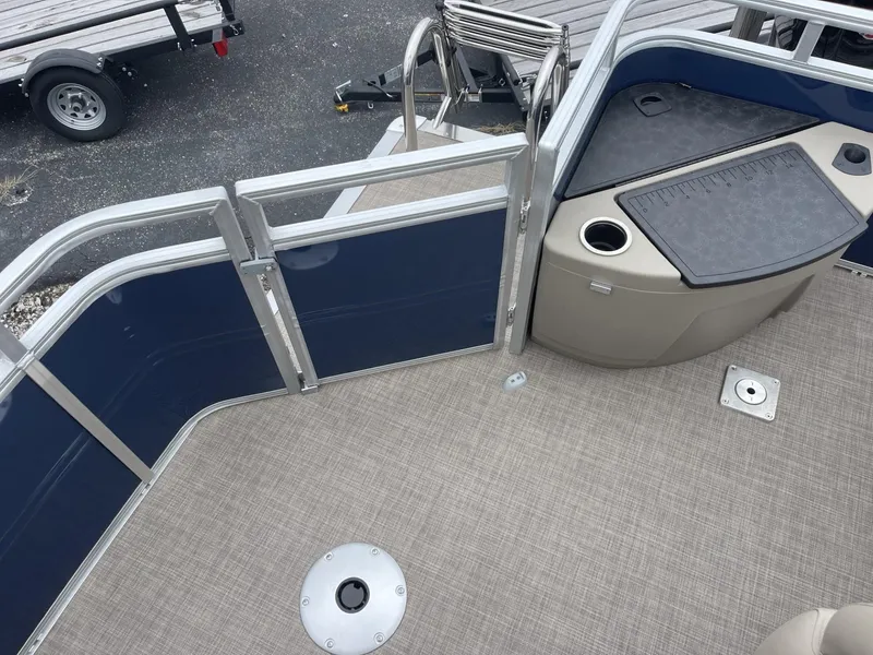 Slide: The Image of 2025 Sun Tracker Fishin' Barge 20 DLX deck with seating and storage area. - 11