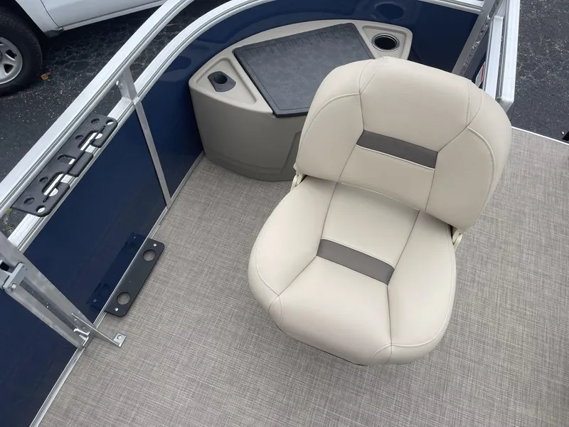 Slide: The Image of Sun Tracker Fishin' Barge 20 DLX 2025 boat interior with beige seating and storage area. - 12
