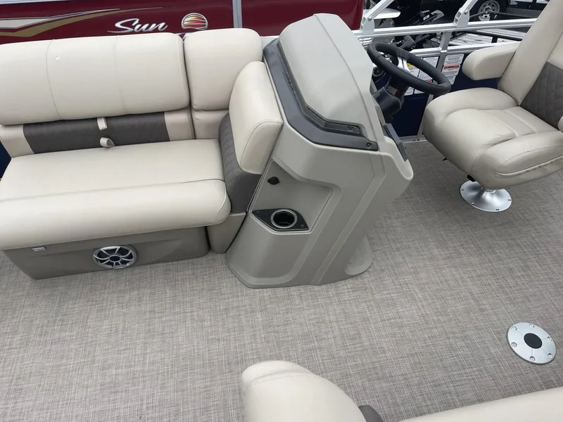 Slide: The Image of Interior of 2025 Sun Tracker Fishin' Barge 20 DLX with beige seating and steering console. - 14