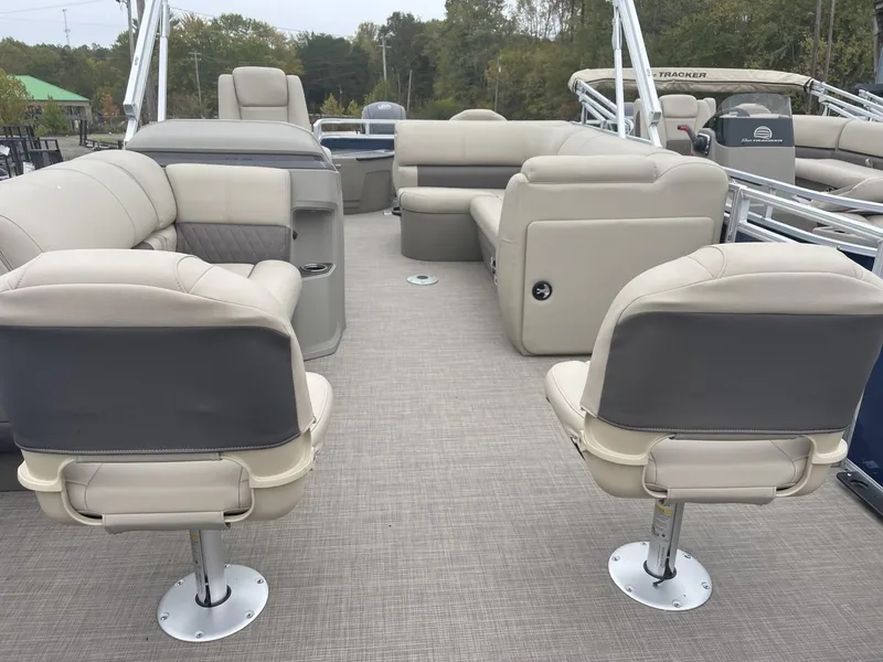 Slide: The Image of 2025 Sun Tracker Fishin' Barge 20 DLX interior with beige seating and spacious layout. - 6