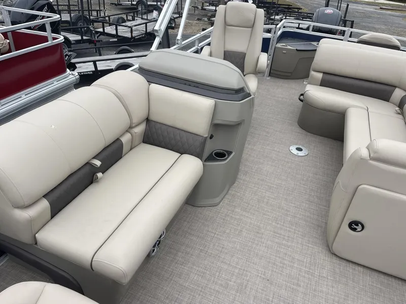 Slide: The Image of 2025 Sun Tracker Fishin' Barge 20 DLX interior with beige seating and spacious layout. - 7