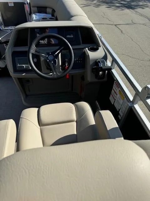Slide: The Image of 2025 Sun Tracker Party Barge 20 DLX interior with steering wheel and seating. - 2