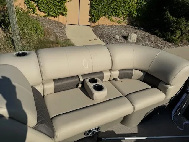 Slide: The Image of 2025 Sun Tracker Party Barge 20 DLX seating with cup holders, beige and brown upholstery. - 3