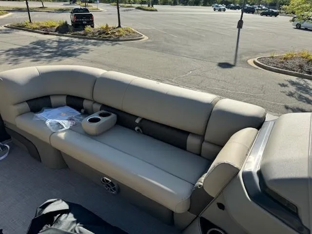 Slide: The Image of 2025 Sun Tracker Party Barge 20 DLX interior seating in a parking lot. - 5