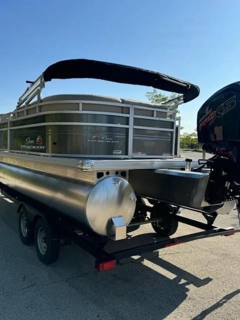 Slide: The Image of 2025 Sun Tracker Party Barge 20 DLX pontoon boat on trailer, rear view. - 7