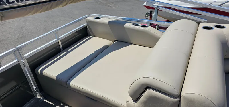 Slide: The Image of 2025 Sun Tracker Party Barge 22 RF XP3 with beige seating and cup holders. - 16
