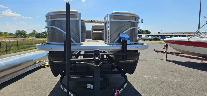 Slide: The Image of 2025 Sun Tracker Party Barge 22 RF XP3 pontoon boat on trailer in sunny lot. - 2