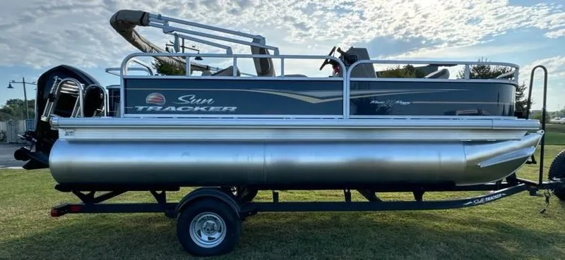 Slide: The Image of 2025 Sun Tracker Bass Buggy 18 DLX pontoon boat on trailer, side view. - 4