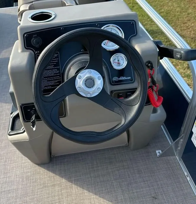 Slide: The Image of 2025 Sun Tracker Bass Buggy 18 DLX steering console with gauges and controls. - 6