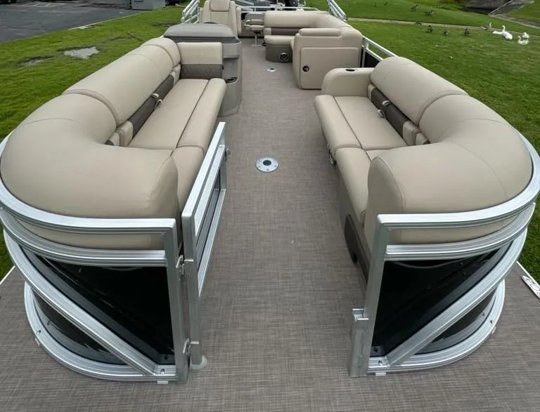Slide: The Image of 2025 Sun Tracker SportFish 22 DLX pontoon boat with spacious seating and modern design. - 5