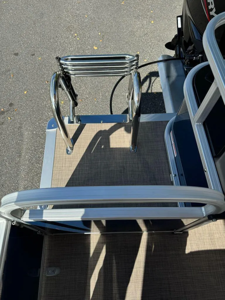 Slide: The Image of 2025 Sun Tracker Bass Buggy 18 DLX boat ladder and deck view. - 13