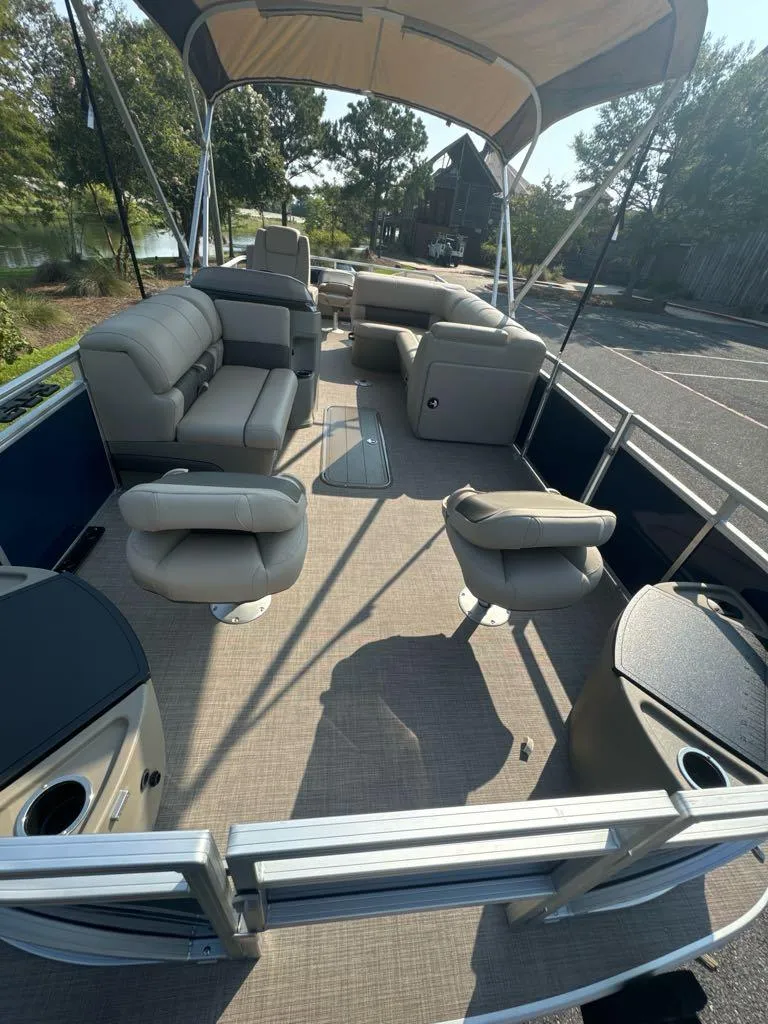 Slide: The Image of 2025 Sun Tracker Fishin' Barge 22 XP3 interior with seating and canopy. - 3