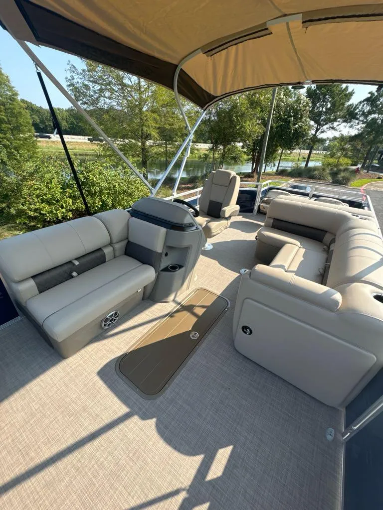Slide: The Image of 2025 Sun Tracker Fishin' Barge 22 XP3 interior with plush seating and canopy. - 4