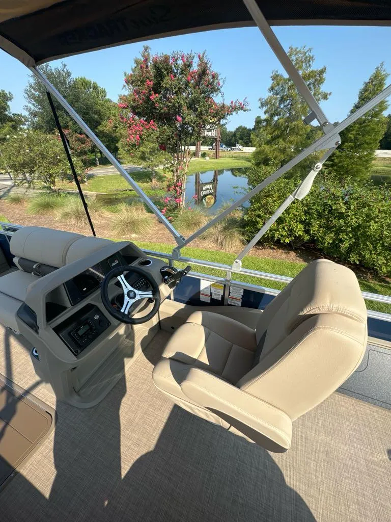 Slide: The Image of 2025 Sun Tracker Fishin' Barge 22 XP3 interior with steering console and seating. - 5