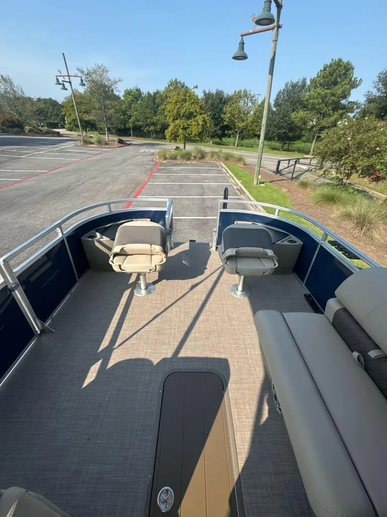 Slide: The Image of 2025 Sun Tracker Fishin' Barge 22 XP3 pontoon boat with spacious seating and outdoor view. - 7