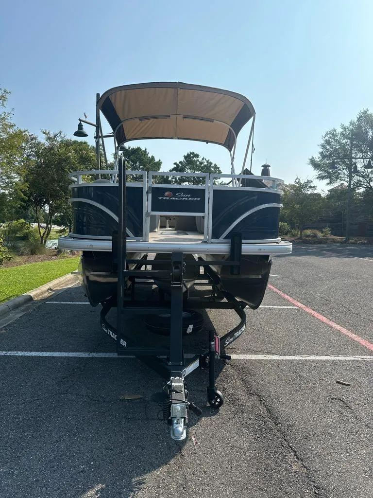 Slide: The Image of 2025 Sun Tracker Fishin' Barge 22 XP3 pontoon boat on trailer in parking lot. - 8