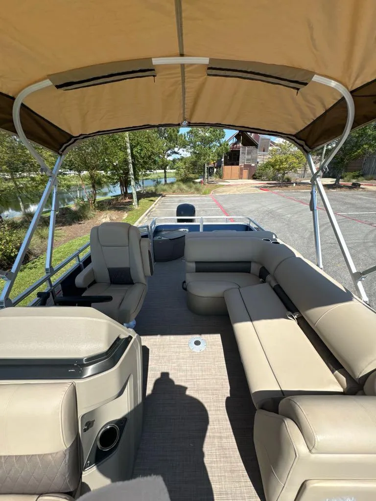 Slide: The Image of 2025 Sun Tracker Fishin' Barge 20 DLX with spacious seating and canopy. - 5