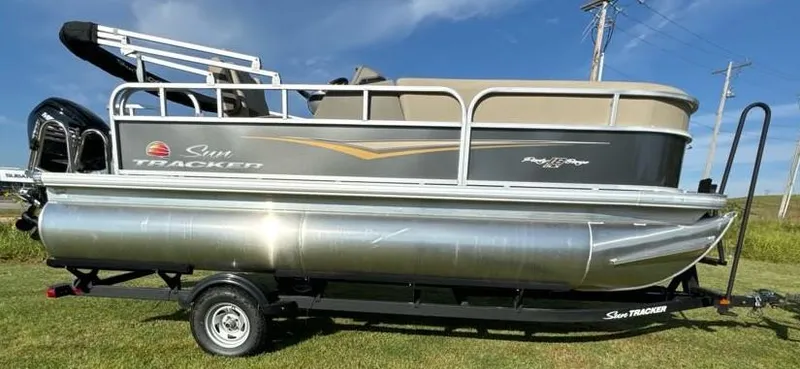 Slide: The Image of 2025 Sun Tracker Party Barge 18 DLX pontoon boat on trailer, side view. - 5