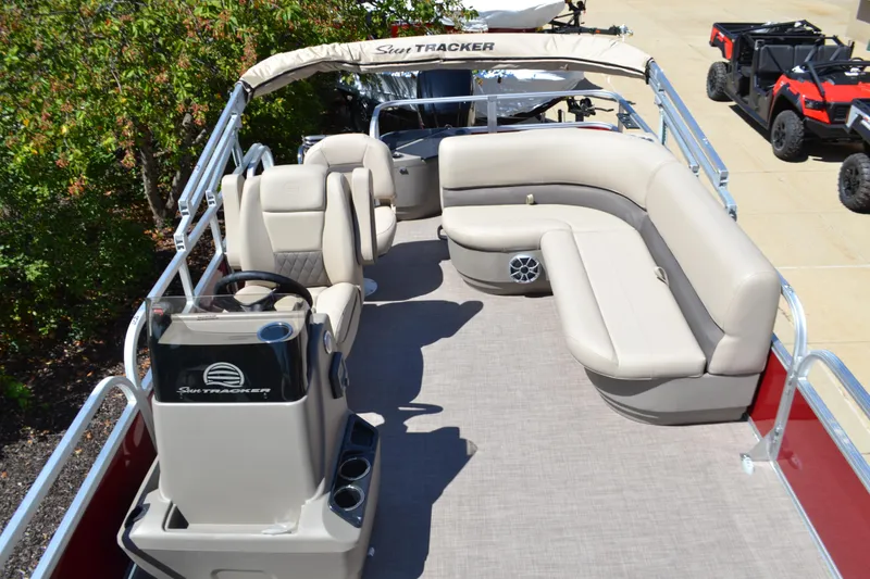 Slide: The Image of 2025 Sun Tracker Bass Buggy 18 DLX pontoon boat with spacious seating and helm. - 2