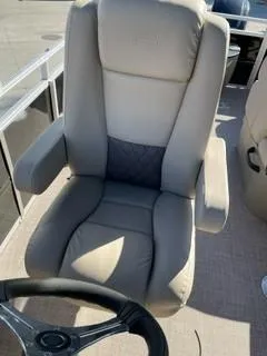 Slide: The Image of 2025 Sun Tracker SportFish 20 DLX captain's chair, beige upholstery, boat interior. - 6