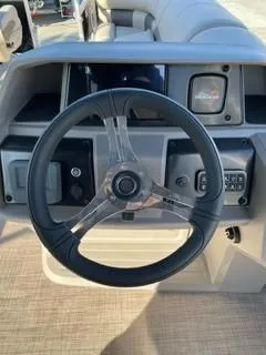 Slide: The Image of 2025 Sun Tracker SportFish 20 DLX steering wheel and dashboard close-up. - 8
