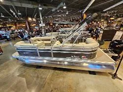 Slide: The Image of 2025 Sun Tracker Party Barge 20 DLX pontoon boat displayed indoors. - 2