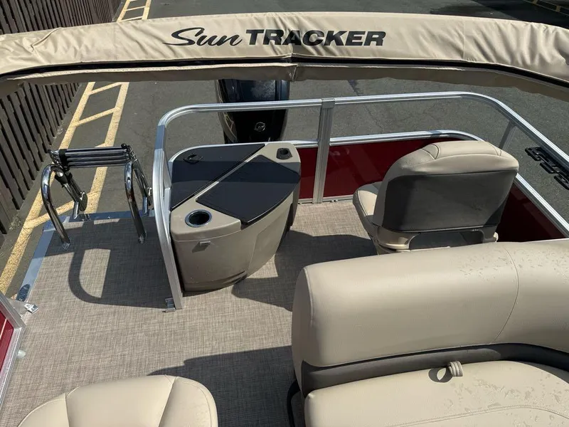 Slide: The Image of 2025 Sun Tracker Bass Buggy 18 DLX pontoon boat interior with seating and storage. - 4