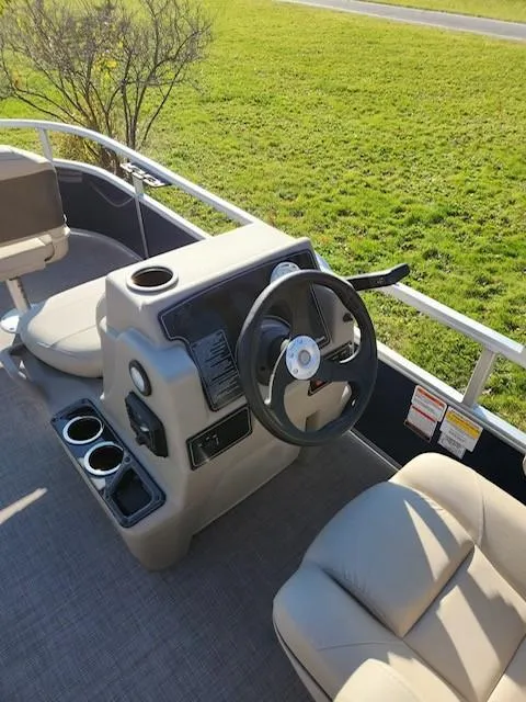 Slide: The Image of 2025 Sun Tracker Bass Buggy 16 XL Select boat interior with steering console and seating. - 4