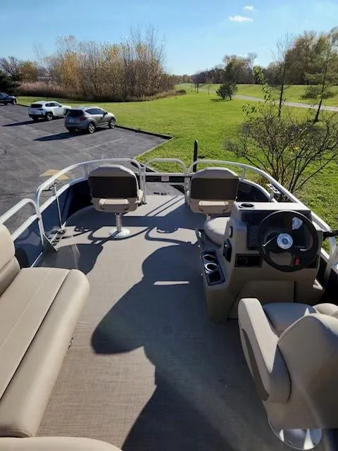 Slide: The Image of 2025 Sun Tracker Bass Buggy 16 XL Select pontoon boat interior with seating and steering console. - 5