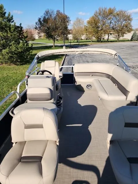 Slide: The Image of 2025 Sun Tracker Bass Buggy 16 XL Select pontoon boat with spacious seating and scenic background. - 6