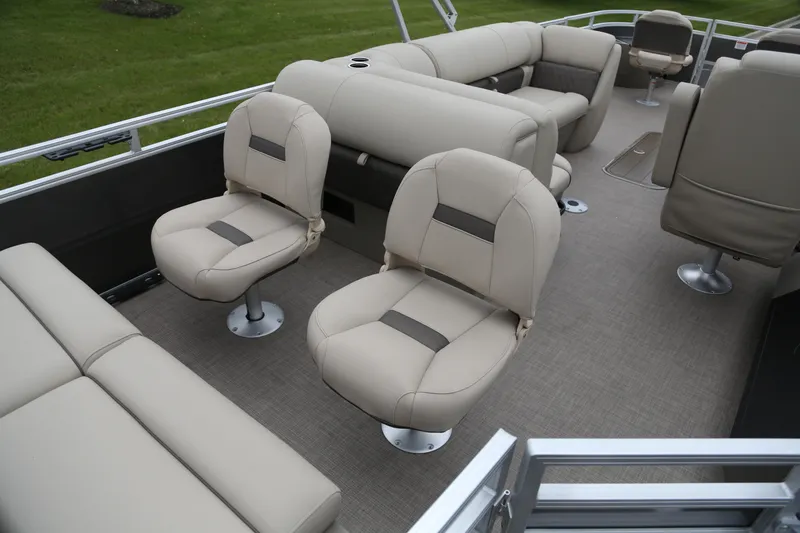 Slide: The Image of 2025 Sun Tracker Fishin' Barge 22 XP3 interior with beige seating and spacious layout. - 3