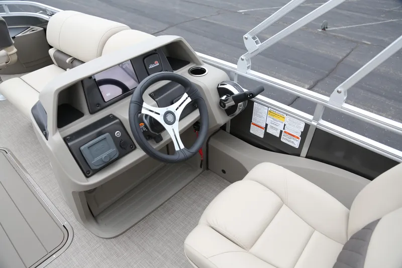 Slide: The Image of Interior view of 2025 Sun Tracker Fishin' Barge 22 XP3 boat's helm and seating area. - 4