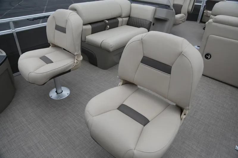 Slide: The Image of 2025 Sun Tracker Fishin' Barge 22 XP3 interior with beige seating and spacious layout. - 6