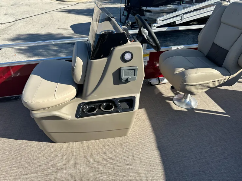 Slide: The Image of 2025 Sun Tracker Bass Buggy 16 XL Select boat interior with beige seating and steering console. - 3