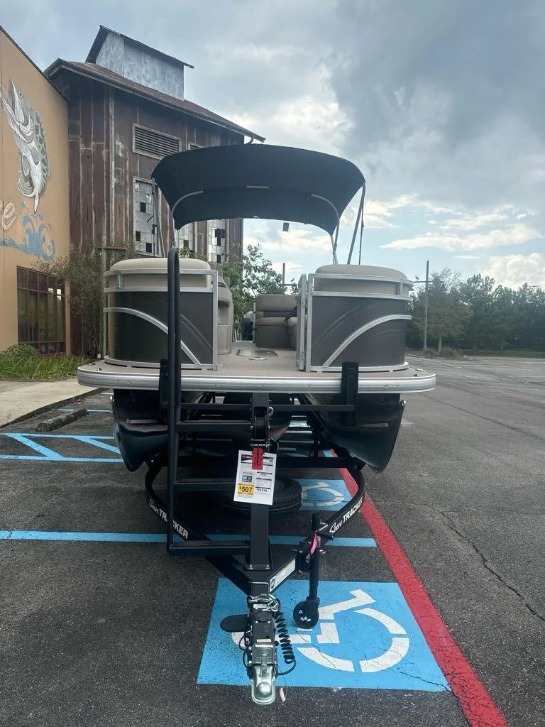 Slide: The Image of 2025 Sun Tracker Party Barge 22 RF XP3 pontoon boat parked in a lot. - 3