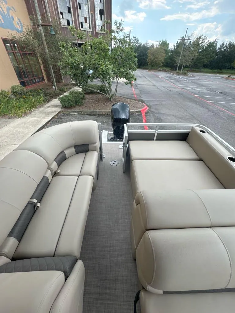Slide: The Image of 2025 Sun Tracker Party Barge 22 RF XP3 pontoon boat interior with seating and motor. - 4