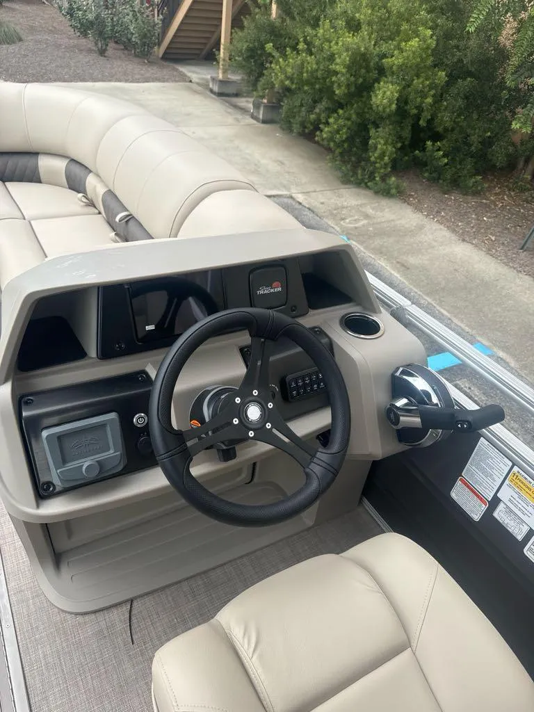 Slide: The Image of 2025 Sun Tracker Party Barge 22 RF XP3 steering console with plush seating. - 7