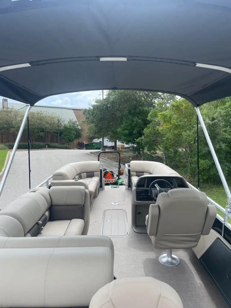 Slide: The Image of 2025 Sun Tracker SportFish 22 XP3 pontoon boat with spacious seating and canopy. - 4