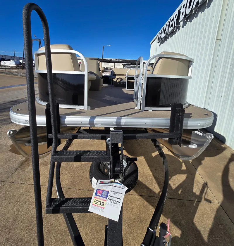 Slide: The Image of 2025 Sun Tracker Party Barge 16 DLX pontoon boat on trailer, displayed outdoors. - 4