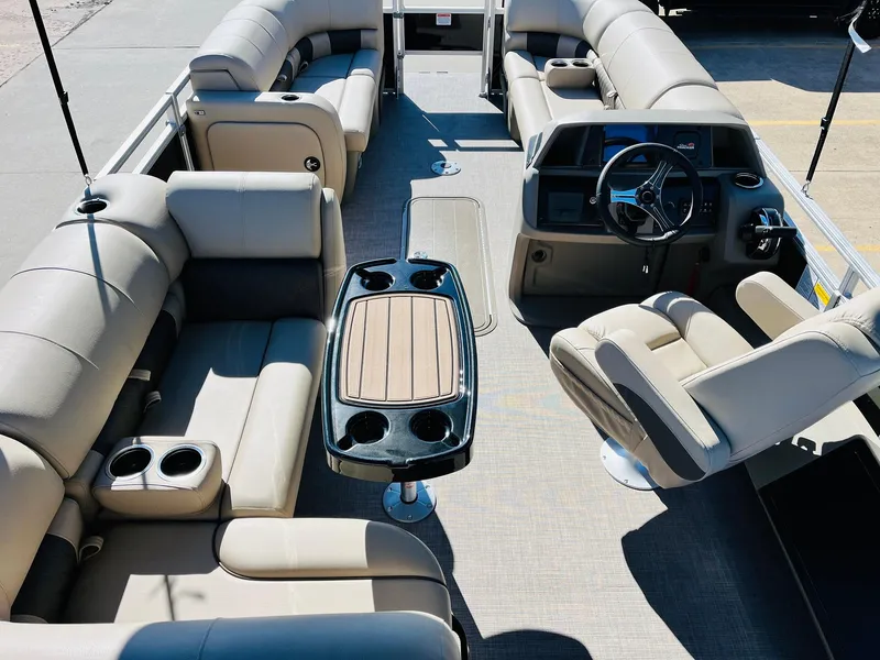 Slide: The Image of 2025 Sun Tracker SportFish 22 XP3 pontoon boat interior with plush seating and modern helm. - 10
