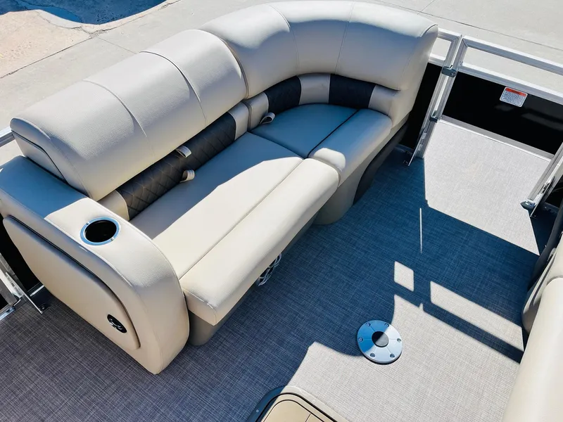Slide: The Image of 2025 Sun Tracker SportFish 22 XP3 pontoon boat with beige seating and cup holder. - 12