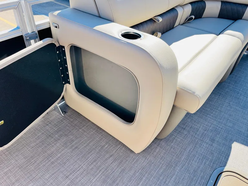 Slide: The Image of 2025 Sun Tracker SportFish 22 XP3 boat interior with open storage compartment and cushioned seating. - 13