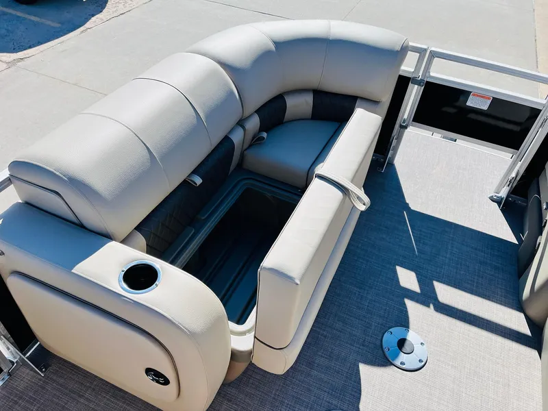 Slide: The Image of 2025 Sun Tracker SportFish 22 XP3 pontoon boat with beige seating and storage compartment. - 16